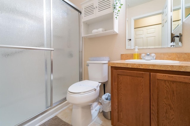 5101 Staniard Dr, Kissimmee, FL 34746 - bathroom featuring tile patterned floors, toilet, vanity, and a stall shower