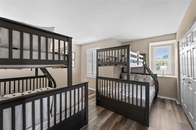 5101 Staniard Dr, Kissimmee, FL 34746 - bedroom with a textured ceiling, wood finished floors, baseboards, and a closet