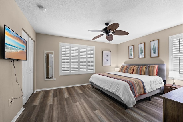 5101 Staniard Dr, Kissimmee, FL 34746 - bedroom featuring a textured ceiling, wood finished floors, ceiling fan, and baseboards