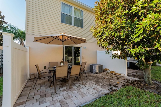 5101 Staniard Dr, Kissimmee, FL 34746 - view of patio / terrace featuring outdoor dining area, fence, and central AC unit