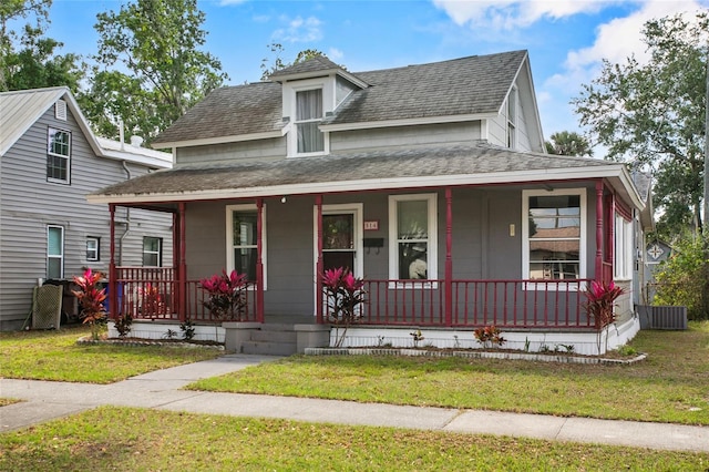 514 Massachusetts Ave, Saint Cloud, FL 34769 - view of front facade featuring central air condition unit, a front lawn, a porch, and roof with shingles