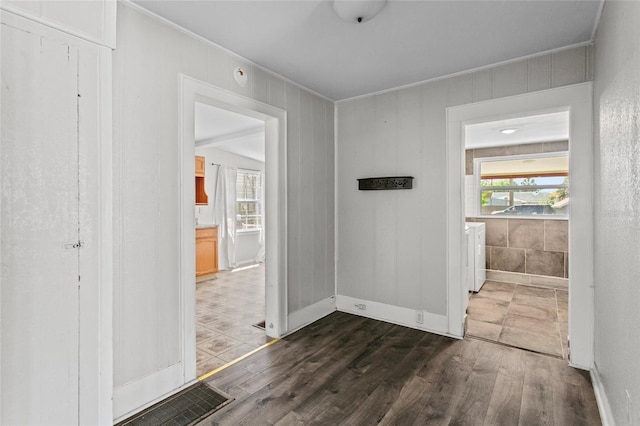 514 Massachusetts Ave, Saint Cloud, FL 34769 - corridor featuring independent washer and dryer, visible vents, dark wood-type flooring, and a wealth of natural light