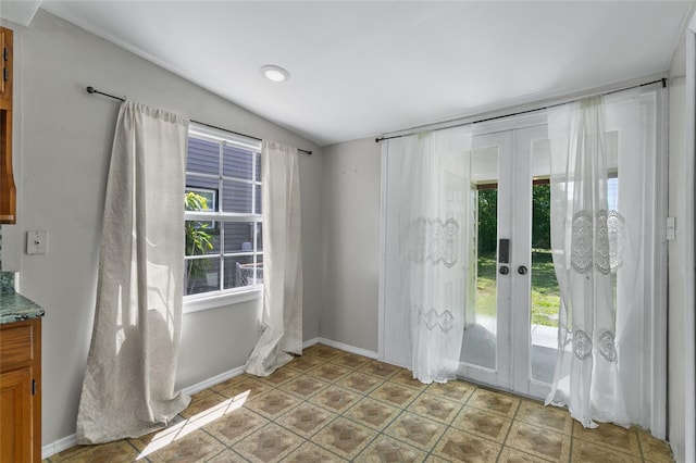 514 Massachusetts Ave, Saint Cloud, FL 34769 - doorway with french doors, vaulted ceiling, light tile patterned floors, and a healthy amount of sunlight