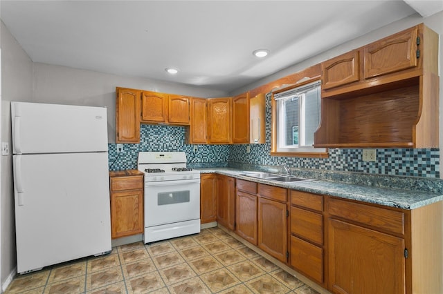 514 Massachusetts Ave, Saint Cloud, FL 34769 - kitchen featuring brown cabinetry, a sink, tasteful backsplash, and white appliances