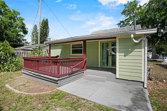 514 Massachusetts Ave, Saint Cloud, FL 34769 - back of house featuring fence, roof with shingles, french doors, and a deck