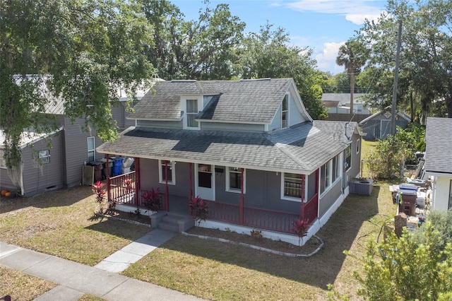 514 Massachusetts Ave, Saint Cloud, FL 34769 - bungalow-style house featuring central AC unit, a front lawn, a porch, and roof with shingles