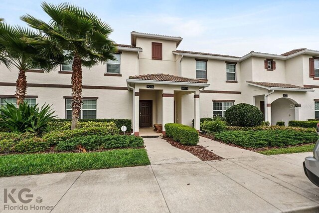 9075 Dogleg Dr, Davenport, FL 33896 - view of front of property featuring stucco siding and a tile roof