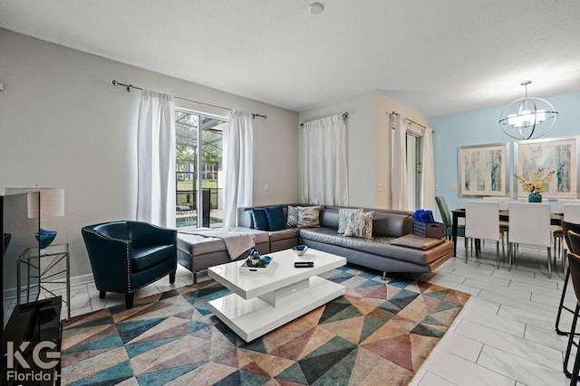 9075 Dogleg Dr, Davenport, FL 33896 - living area with a textured ceiling and an inviting chandelier