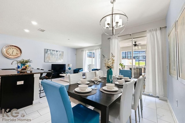 9075 Dogleg Dr, Davenport, FL 33896 - dining room with baseboards, marble finish floor, a notable chandelier, and visible vents