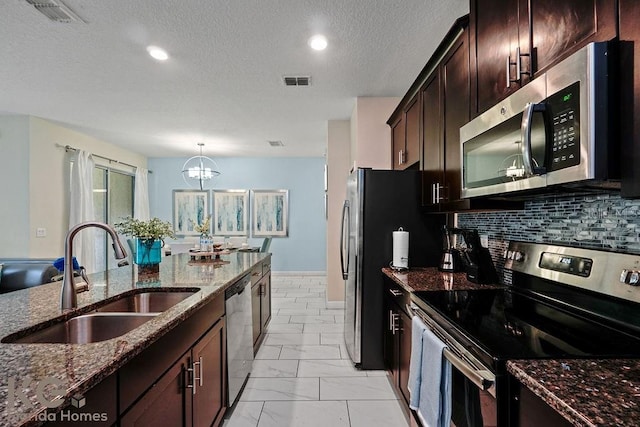 9075 Dogleg Dr, Davenport, FL 33896 - kitchen featuring visible vents, a sink, dark stone counters, stainless steel appliances, and marble finish floor