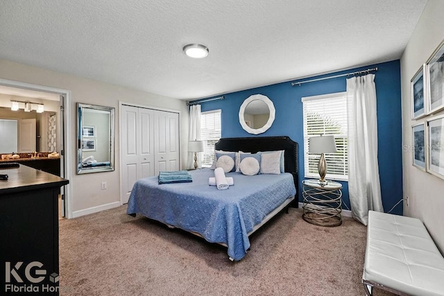 9075 Dogleg Dr, Davenport, FL 33896 - carpeted bedroom with a textured ceiling, a closet, and baseboards