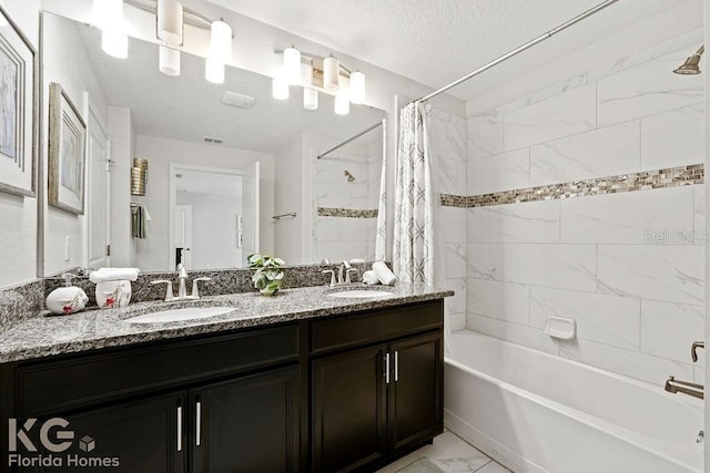9075 Dogleg Dr, Davenport, FL 33896 - full bathroom with shower / tub combo, marble finish floor, a sink, and a textured ceiling