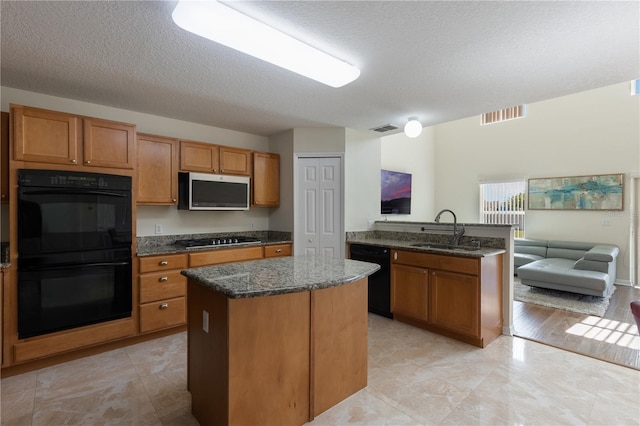 7716 Park Hill Ave, Leesburg, FL 34748 - kitchen featuring black appliances, a sink, open floor plan, a center island, and dark stone countertops