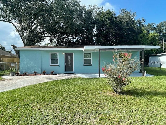 ranch-style home with fence and a front yard