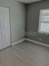 unfurnished bedroom featuring baseboards and wood finished floors