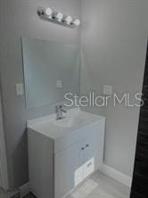 bathroom featuring baseboards and vanity