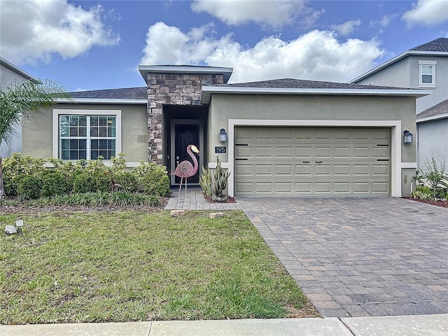 195 Preston Ave, Davenport, FL 33837 - view of front of home with a garage, stucco siding, decorative driveway, and a front yard