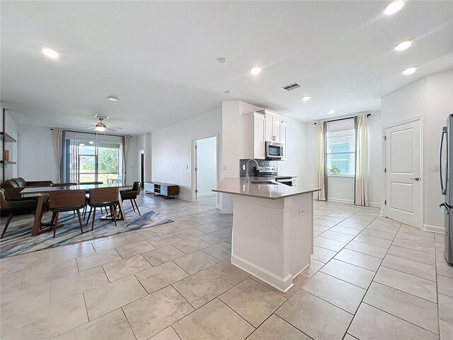 195 Preston Ave, Davenport, FL 33837 - kitchen featuring recessed lighting, visible vents, a peninsula, white cabinets, and appliances with stainless steel finishes