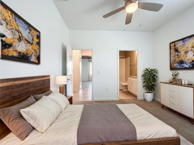 195 Preston Ave, Davenport, FL 33837 - bedroom featuring light colored carpet, ceiling fan, connected bathroom, and baseboards