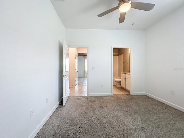 195 Preston Ave, Davenport, FL 33837 - unfurnished bedroom featuring baseboards, a ceiling fan, connected bathroom, and light colored carpet