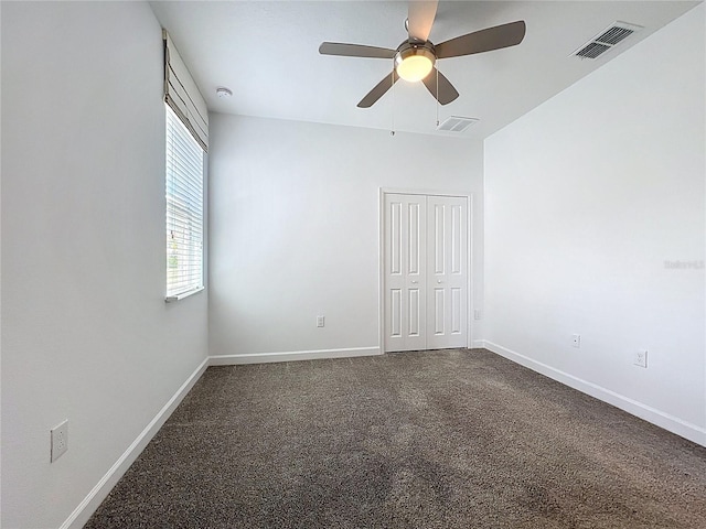 195 Preston Ave, Davenport, FL 33837 - empty room with dark colored carpet, visible vents, and baseboards