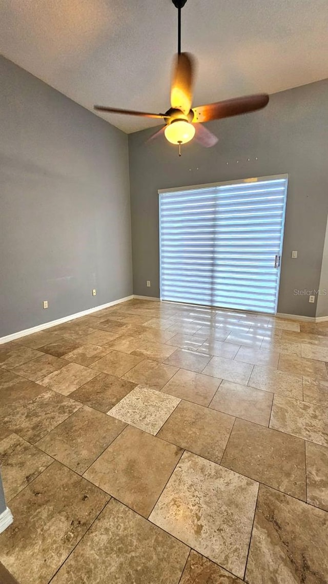 spare room with a ceiling fan, baseboards, and a textured ceiling