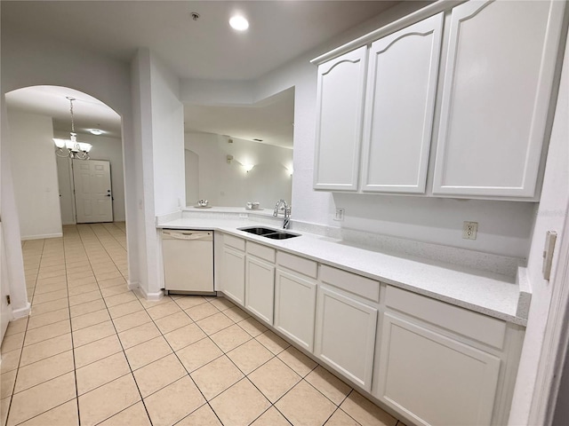 3300 Whitestone Cir Unit 201, Kissimmee, FL 34741 - kitchen featuring white dishwasher, arched walkways, light tile patterned floors, white cabinets, and a chandelier