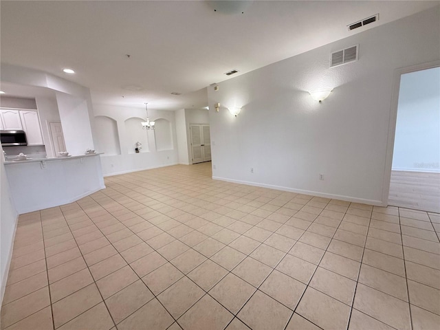 3300 Whitestone Cir Unit 201, Kissimmee, FL 34741 - unfurnished living room with light tile patterned flooring, a chandelier, and recessed lighting