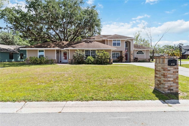 1730 King Henry Dr, Kissimmee, FL 34744 - view of front facade featuring concrete driveway and a front lawn