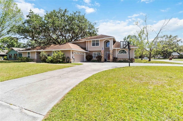 1730 King Henry Dr, Kissimmee, FL 34744 - view of front of property featuring stone siding, driveway, a front lawn, and an attached garage