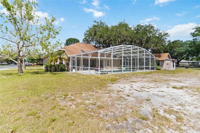 1730 King Henry Dr, Kissimmee, FL 34744 - rear view of house featuring a lanai and a yard