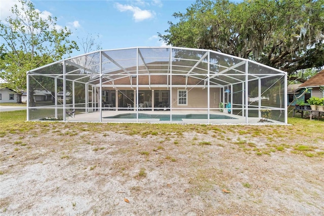 1730 King Henry Dr, Kissimmee, FL 34744 - back of house with glass enclosure, an outdoor pool, and a patio area