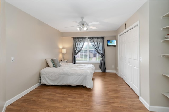 1730 King Henry Dr, Kissimmee, FL 34744 - bedroom featuring a ceiling fan, baseboards, a closet, and wood finished floors