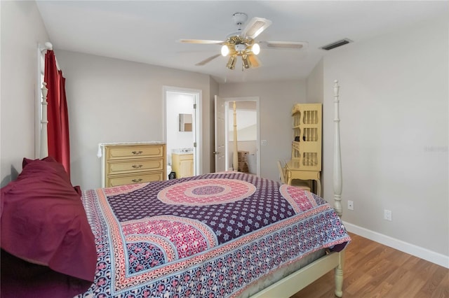 1730 King Henry Dr, Kissimmee, FL 34744 - bedroom with visible vents, baseboards, connected bathroom, wood finished floors, and a ceiling fan