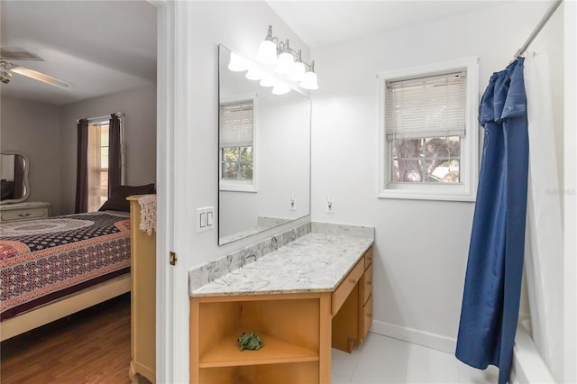 1730 King Henry Dr, Kissimmee, FL 34744 - ensuite bathroom featuring a shower with curtain, vanity, baseboards, ensuite bath, and ceiling fan