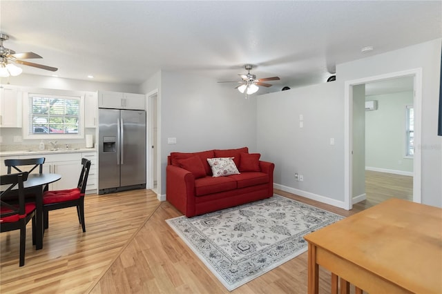 1730 King Henry Dr, Kissimmee, FL 34744 - living area with baseboards, ceiling fan, and light wood-style flooring