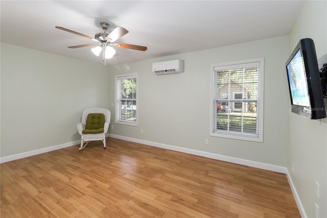 1730 King Henry Dr, Kissimmee, FL 34744 - unfurnished room featuring baseboards, a wall mounted AC, ceiling fan, and light wood finished floors