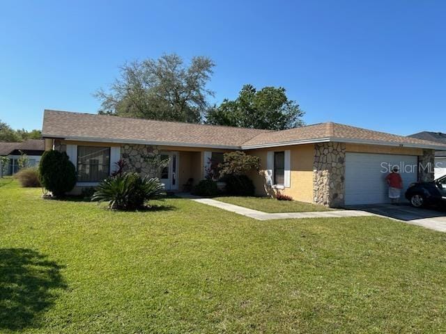 133 Bianca Ct, Kissimmee, FL 34758 - single story home with stone siding, driveway, a front lawn, and an attached garage