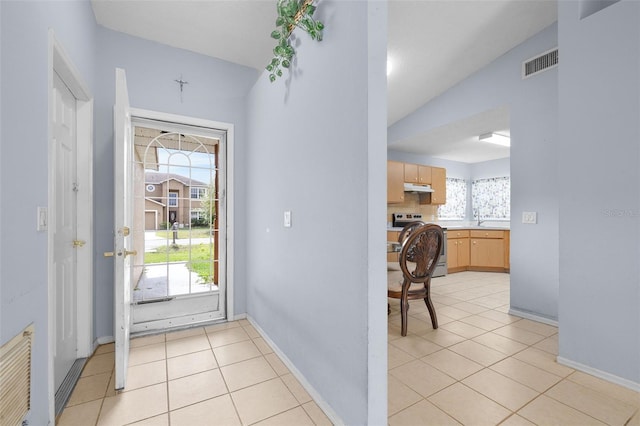 101 Cheltenham Pl, Kissimmee, FL 34758 - entrance foyer featuring baseboards, visible vents, vaulted ceiling, and light tile patterned floors