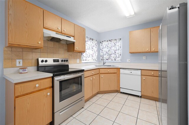 101 Cheltenham Pl, Kissimmee, FL 34758 - kitchen with a sink, light brown cabinetry, dishwasher, stainless steel electric range, and under cabinet range hood