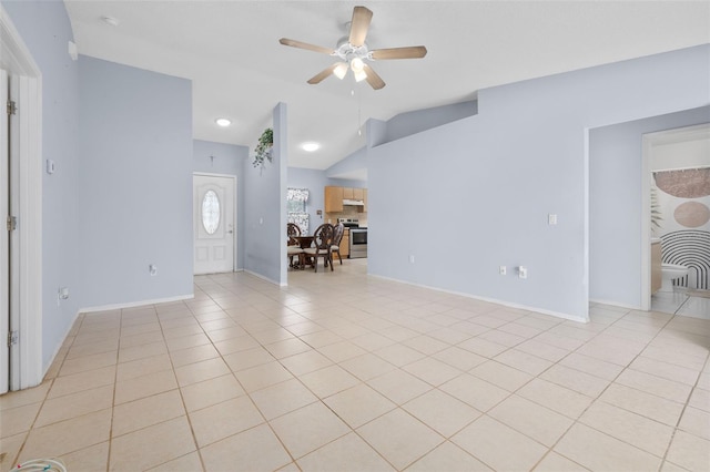 101 Cheltenham Pl, Kissimmee, FL 34758 - unfurnished living room featuring baseboards, vaulted ceiling, light tile patterned floors, and a ceiling fan