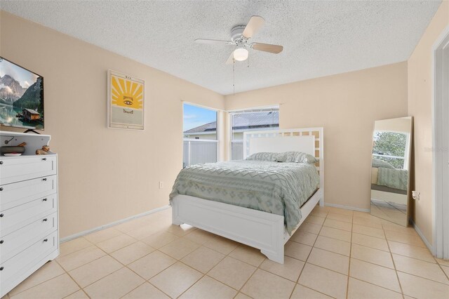101 Cheltenham Pl, Kissimmee, FL 34758 - bedroom featuring a textured ceiling, a ceiling fan, multiple windows, and light tile patterned floors