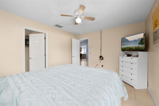 101 Cheltenham Pl, Kissimmee, FL 34758 - bedroom with light tile patterned flooring, visible vents, ceiling fan, and a textured ceiling