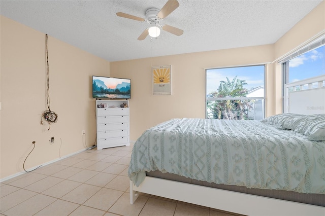 101 Cheltenham Pl, Kissimmee, FL 34758 - bedroom with light tile patterned floors, baseboards, ceiling fan, and a textured ceiling