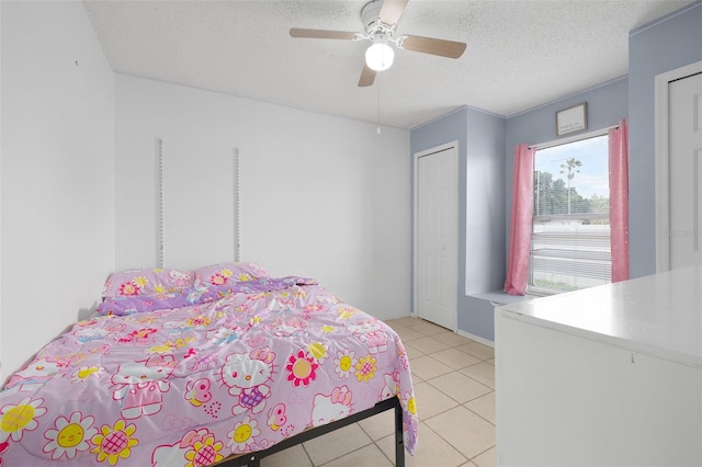 101 Cheltenham Pl, Kissimmee, FL 34758 - bedroom featuring a ceiling fan, light tile patterned flooring, and a textured ceiling