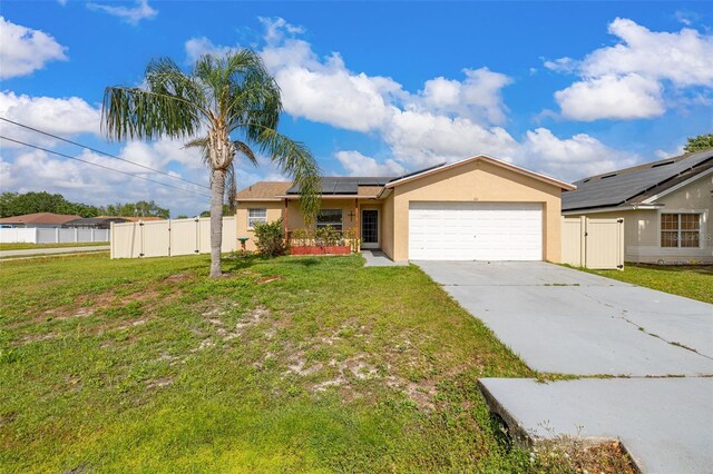101 Cheltenham Pl, Kissimmee, FL 34758 - single story home with a gate, stucco siding, an attached garage, a front lawn, and roof mounted solar panels