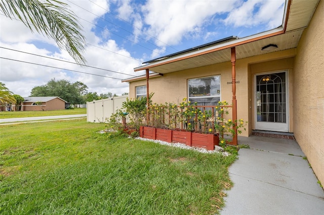 101 Cheltenham Pl, Kissimmee, FL 34758 - exterior space featuring stucco siding, fence, and a lawn