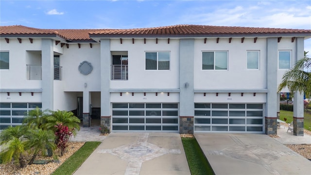 1911 Greenbriar Ter, Davenport, FL 33837 - view of front of home with a garage, driveway, stucco siding, and a tile roof