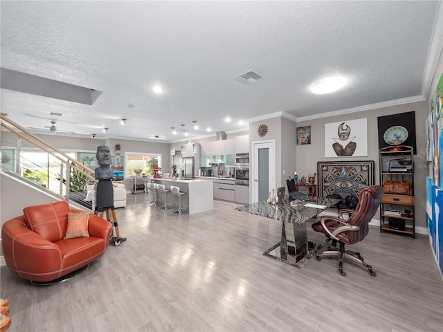 1911 Greenbriar Ter, Davenport, FL 33837 - home office with visible vents, a ceiling fan, light wood-style floors, a textured ceiling, and crown molding