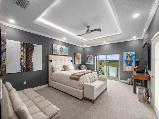 1911 Greenbriar Ter, Davenport, FL 33837 - bedroom featuring a tray ceiling, light carpet, and crown molding